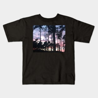 Forest sunset landscape beautiful pink hues in the shadow of sky high pine trees Kids T-Shirt